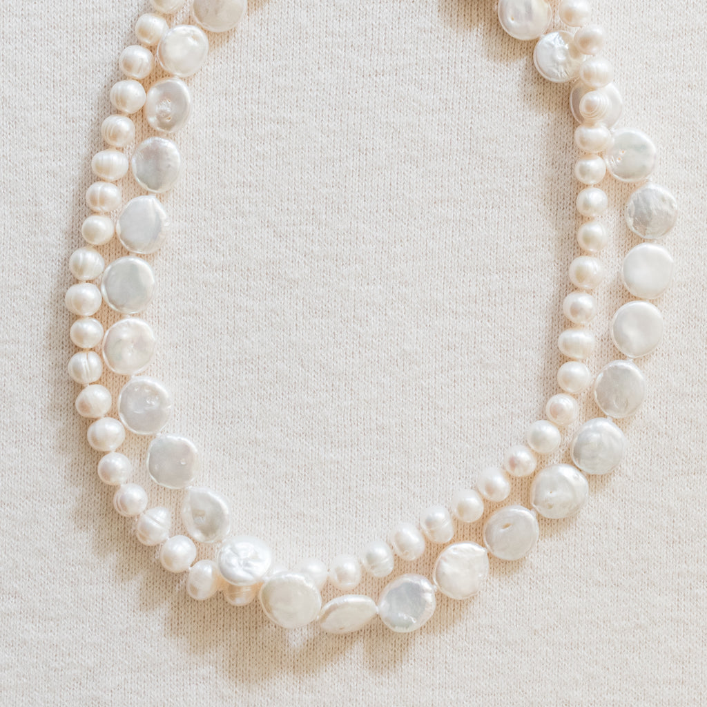 Chloe Pearl Necklace by Pearly Girls is a double strand freshwater pearl necklace. It features two layers of beautifully matched pearls, offering a luxurious and fuller appearance that embodies classic elegance and sophistication in pearl jewelry.