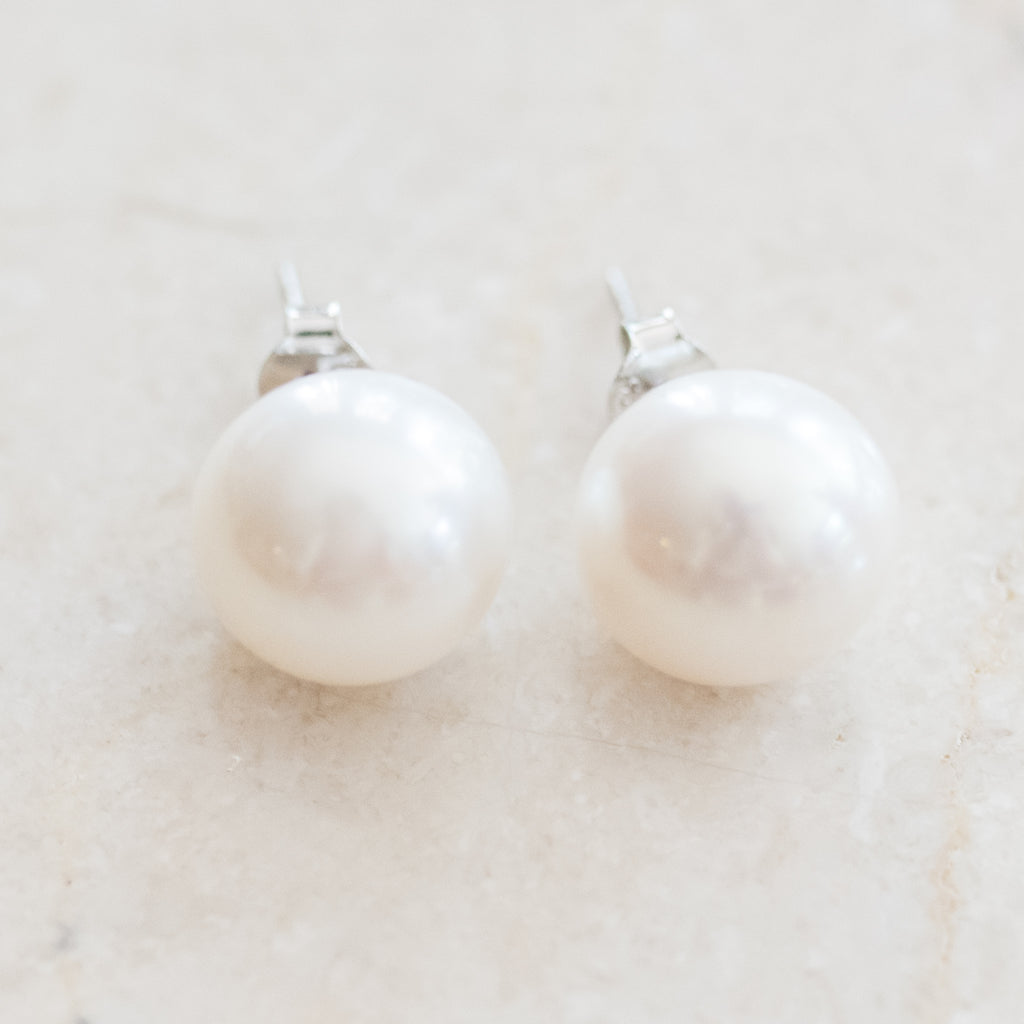 Classic XL Pearl Stud Earrings by Pearly Girls, a statement of bold elegance with radiant luster. These large pearl studs make a striking impact, showcasing the rich, natural sheen of pearls in a design that combines classic style with a bold, contemporary presence.