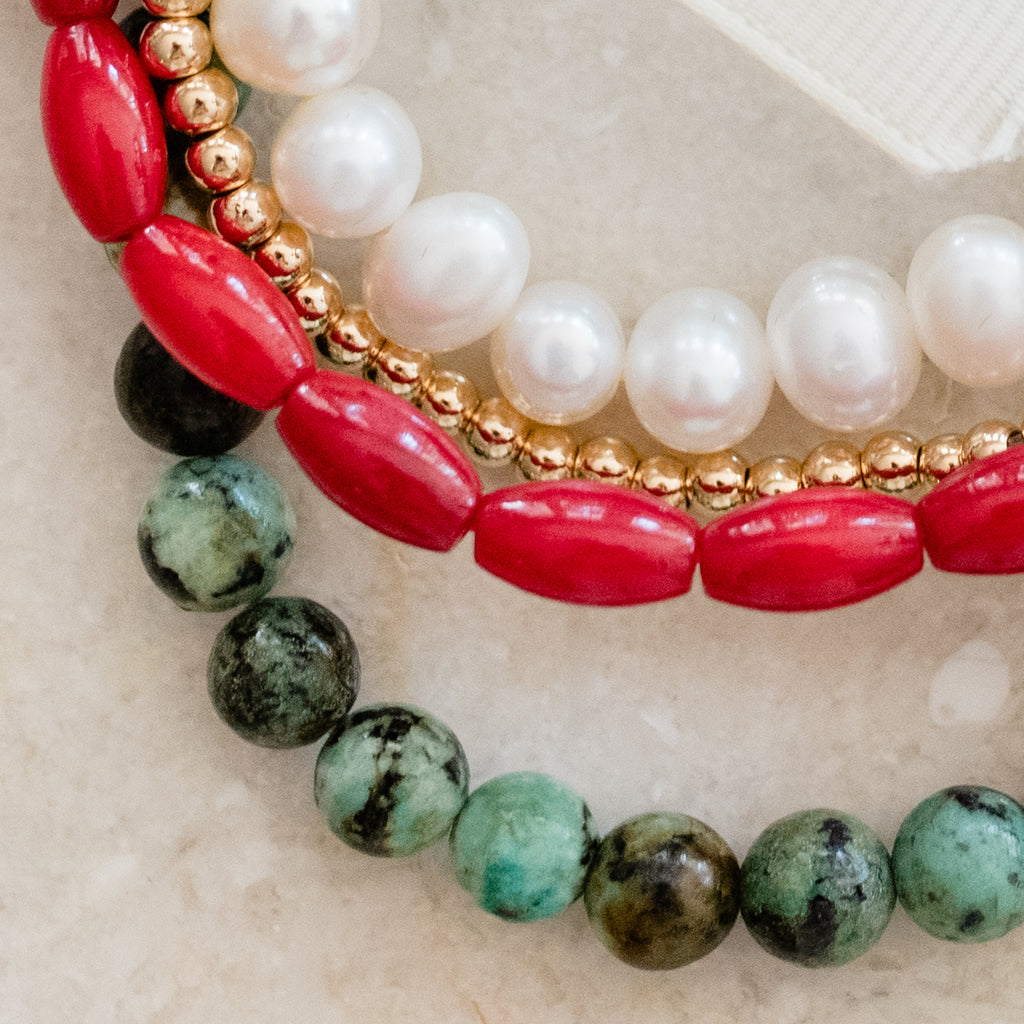 Elegant bracelet bundle by Pearly Girls, showcasing a vibrant mix of African turquoise and pearls. The design combines the unique, earthy tones of turquoise beads with the classic beauty of pearls, creating a visually striking and versatile accessory.