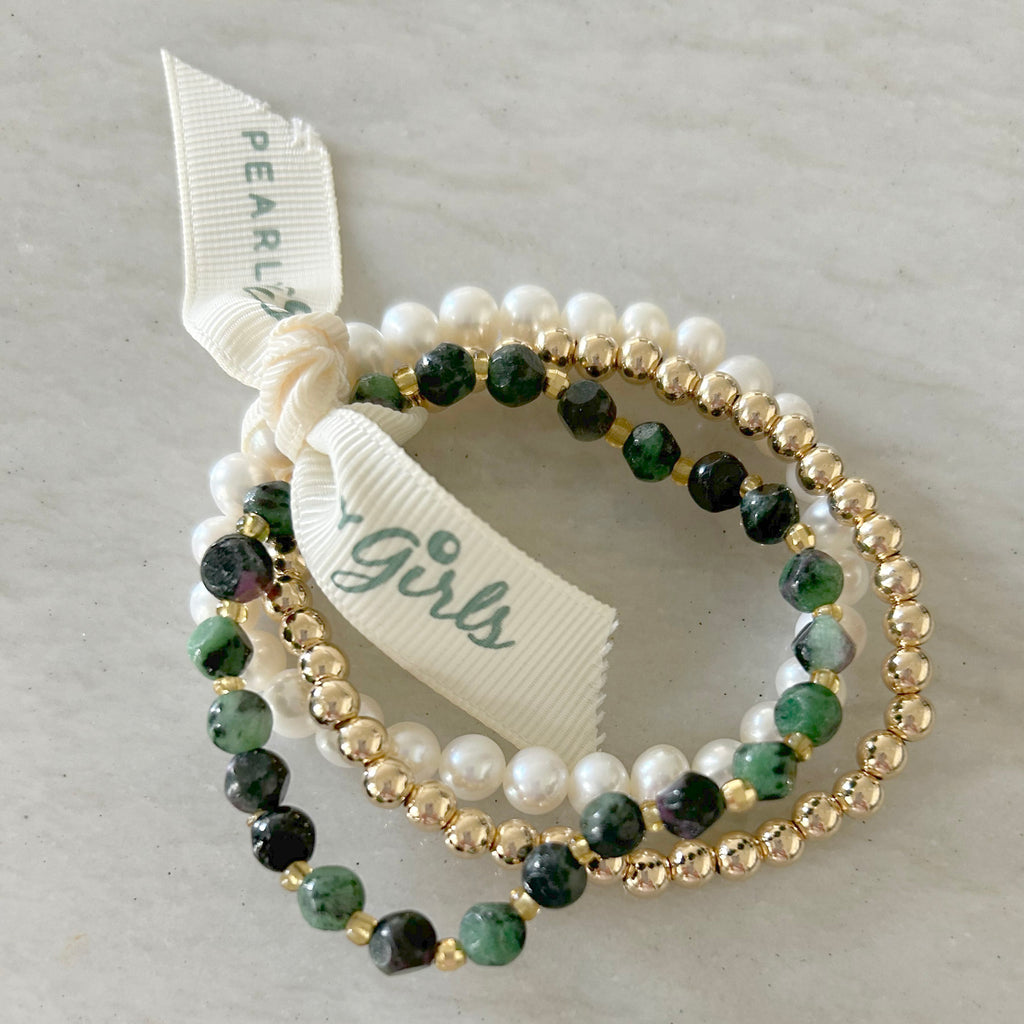 Green Ruby Pearl Bundle by Pearly Girls, a vibrant mix of gemstone and timeless elegance. This bundle pairs the vivid allure of green rubies with the classic sophistication of pearls, creating a striking contrast and a harmonious blend of color and timeless style.