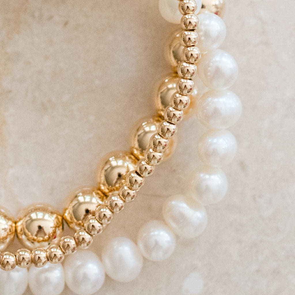Classic Pearl Bracelet Bundle by Pearly Girls, featuring freshwater pearls and gold-filled accents. This bundle combines the timeless beauty of freshwater pearls with the subtle luxury of gold-filled details, creating a sophisticated and versatile collection of bracelets.