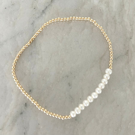 Sarah Simple Gold and Pearl Stretchy Bracelet by Pearly Girls, featuring gold-filled beads with freshwater pearls. This bracelet blends the subtle shine of gold-filled beads with the timeless elegance of freshwater pearls in a stretchy design, offering a chic and comfortable accessory that's perfect for everyday wear.