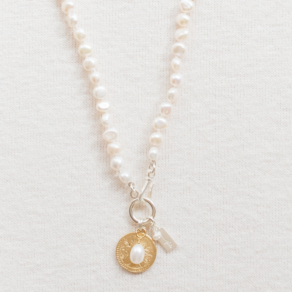 Emily Pearl Necklace by Pearly Girls, available in both 18" and 21" lengths. This necklace is a classic display of elegance, featuring a seamless strand of pearls that offers a timeless look, suitable for various occasions and easily adaptable to different styles and preferences.