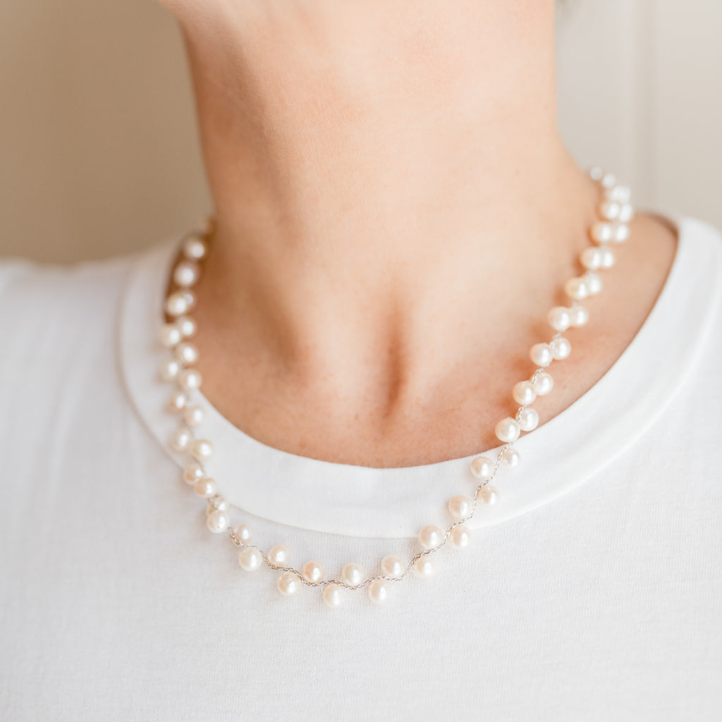 Jane Pearl Necklace by Pearly Girls, a freshwater pearl necklace. This piece showcases the timeless beauty of freshwater pearls, strung together to create a classic and elegant necklace that exemplifies the enduring appeal of pearl jewelry.
