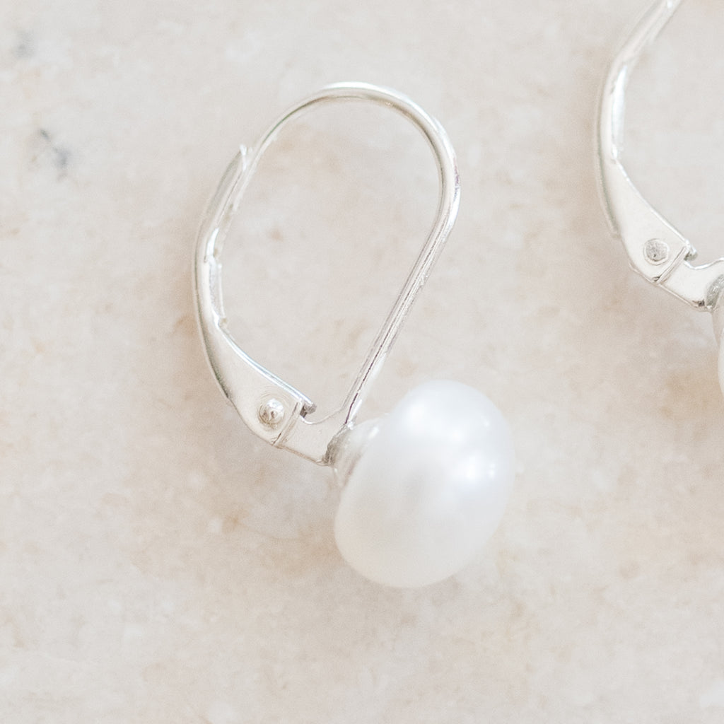 Pearl Studs on Lever Back Earrings by Pearly Girls, embodying timeless elegance with a modern twist. These earrings feature classic pearl studs, securely set on contemporary lever back closures, offering a perfect blend of traditional pearl beauty and modern convenience and style.