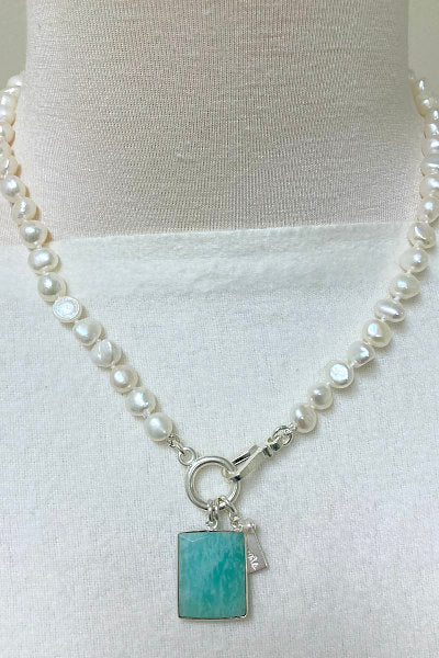 Madeline Pearl Necklace by Pearly Girls, featuring an Amazonite pendant and freshwater pearls. This necklace combines the serene, blue-green hues of an Amazonite pendant with the classic elegance of freshwater pearls, creating a harmonious and stylish piece perfect for various occasions.
