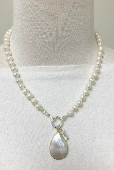 Samantha Pearl Necklace by Pearly Girls, featuring a Mother of Pearl pendant and freshwater pearls. This necklace elegantly combines the iridescent charm of a Mother of Pearl pendant with the classic luster of freshwater pearls, creating a piece that is both sophisticated and gracefully alluring.