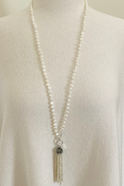 Elise Pearl Necklace by Pearly Girls, featuring freshwater nugget pearls and a crystal bead tassel. This necklace combines the rustic charm of irregularly shaped nugget pearls with the sparkling elegance of a crystal bead tassel, creating a blend of natural beauty and refined glamour.