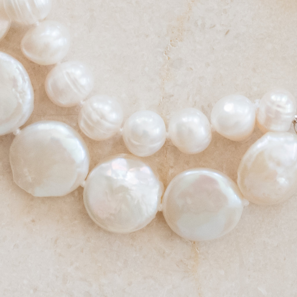 Chloe Pearl Bracelet by Pearly Girls, a double strand pearl bracelet. This piece elegantly layers two strands of lustrous pearls, creating a sophisticated and timeless look that enhances the charm and elegance of classic pearl jewelry.