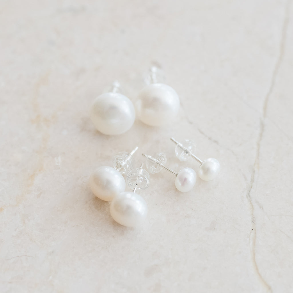 Classic Pearl Stud Earrings by Pearly Girls, showcasing versatile freshwater pearls set in sterling silver. These earrings epitomize elegance with their simple yet sophisticated design, combining the luster of pearls with the durability and shine of sterling silver.