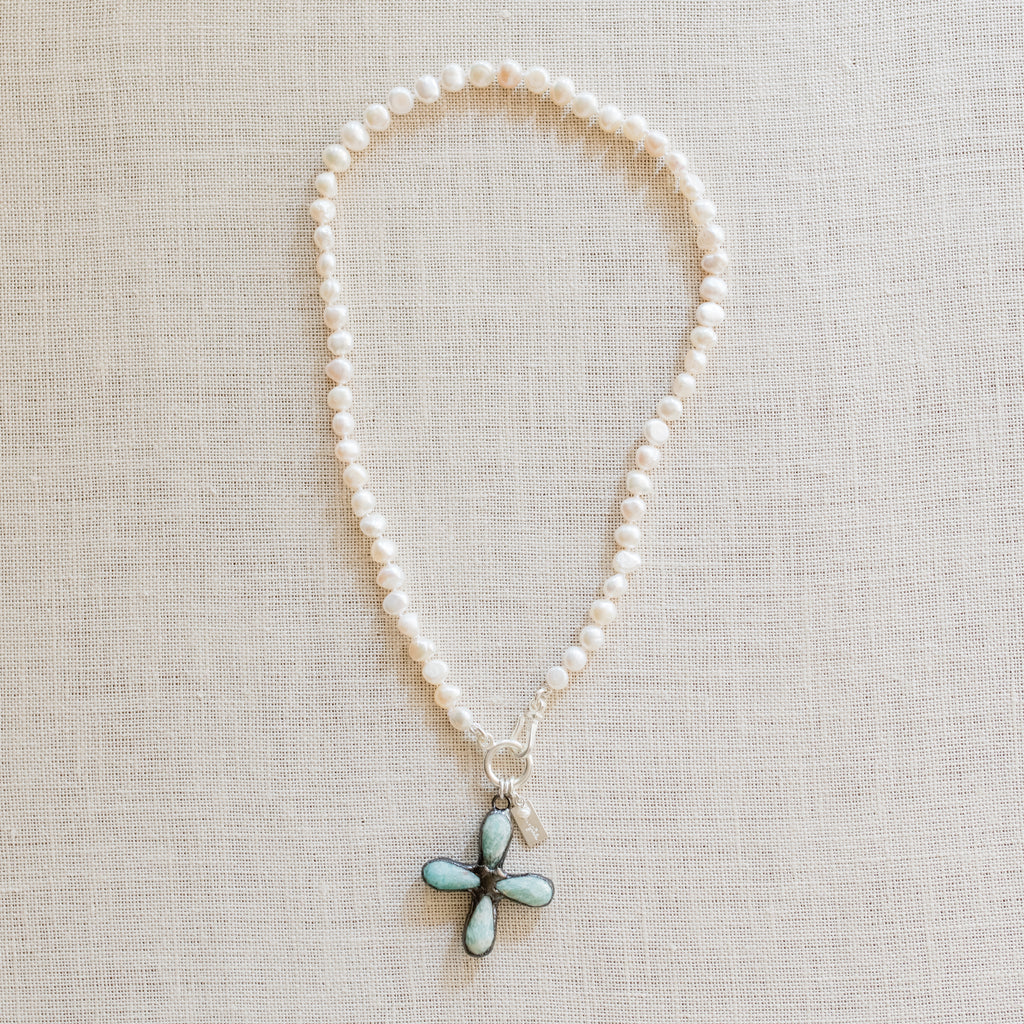 Kylie Pearl Necklace by Pearly Girls, showcasing an artisan Amazonite cross and freshwater pearl necklace. This piece beautifully combines the serene blue-green tones of an Amazonite cross with the classic elegance of freshwater pearls, creating a necklace that's both spiritually meaningful and aesthetically graceful.