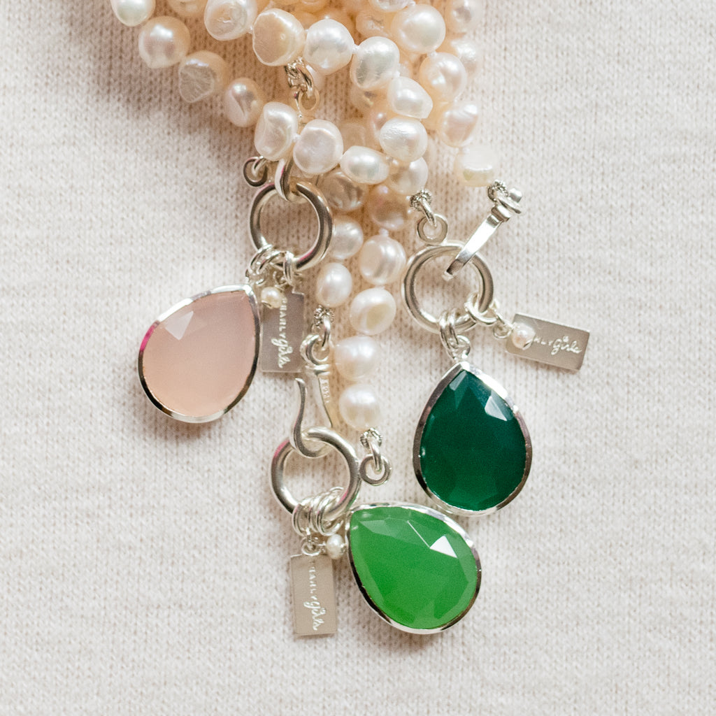 Margaret Pearl Necklace by Pearly Girls, featuring freshwater pearls with a radiant chalcedony pendant. This necklace elegantly combines the classic luster of pearls with the vibrant and translucent beauty of a chalcedony pendant, creating a piece that's both timeless and striking.