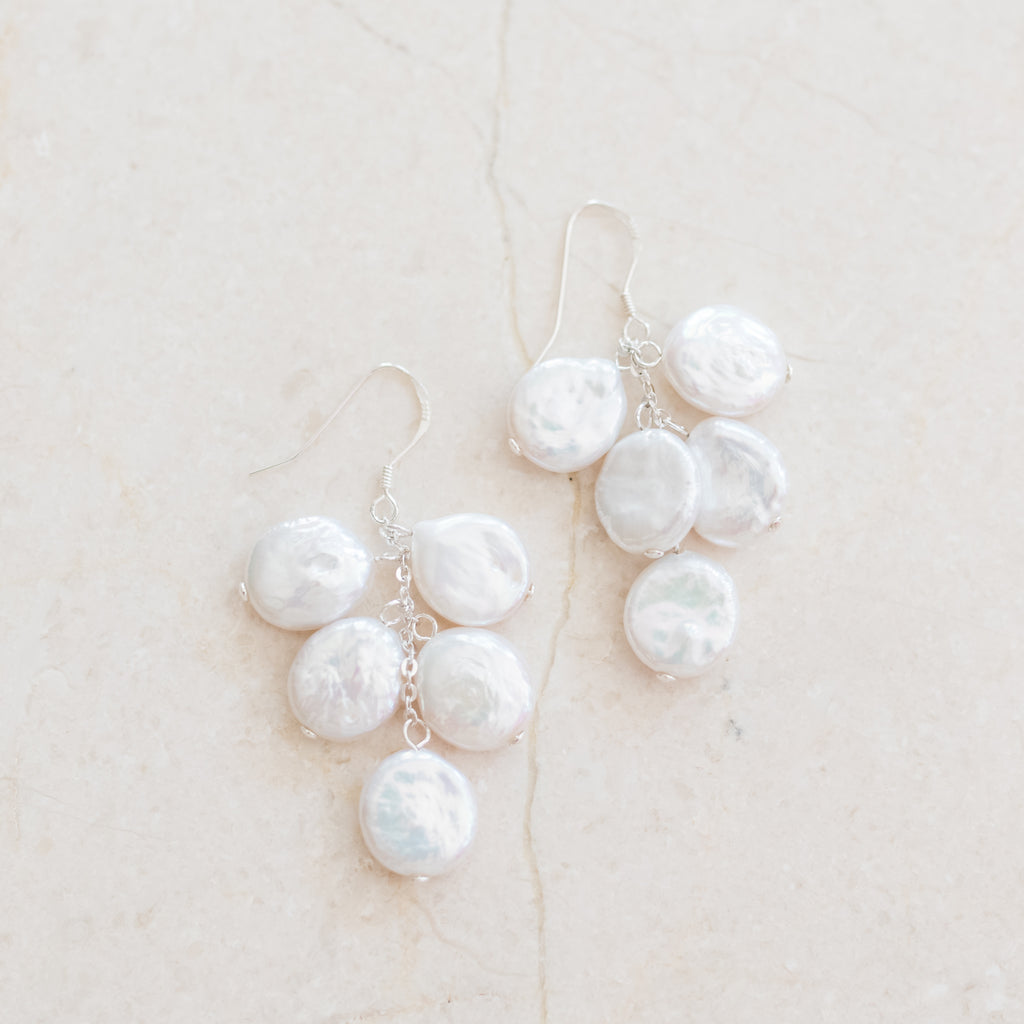 Cascading Coin Pearl Earrings by Pearly Girls, showcasing clustered elegance with sterling silver. These earrings feature an array of coin pearls in a cascading design, complemented by the sleekness of sterling silver, creating a sophisticated and striking look.