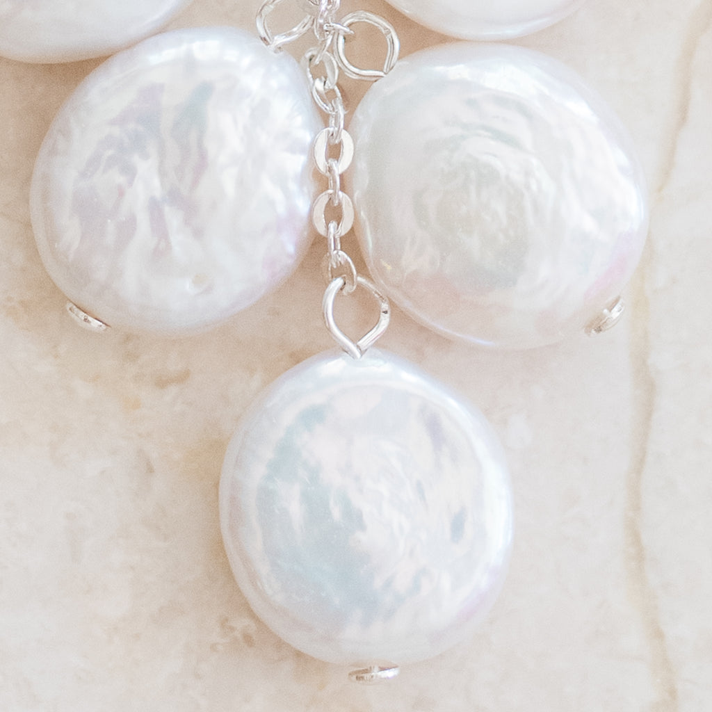 Cascading Coin Pearl Earrings by Pearly Girls, showcasing clustered elegance with sterling silver. These earrings feature an array of coin pearls in a cascading design, complemented by the sleekness of sterling silver, creating a sophisticated and striking look.