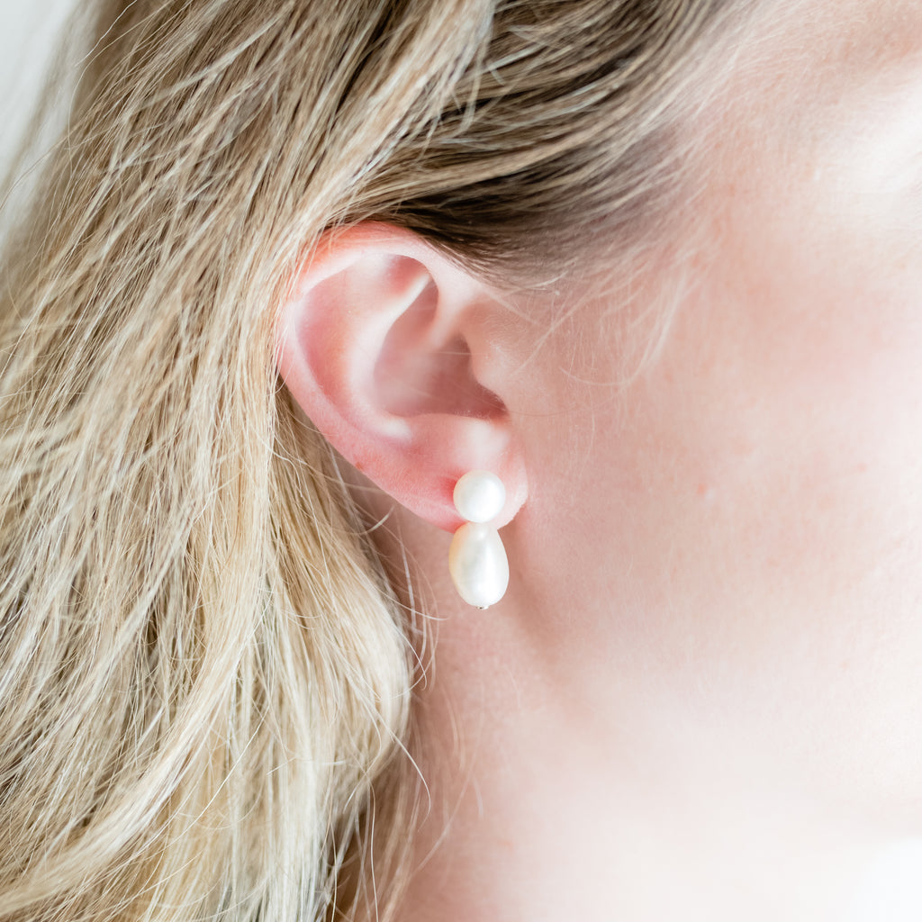 Baroque and Button Pearl Earrings by Pearly Girls merge timeless style with modern flair. These earrings showcase the unique texture of baroque pearls paired with smooth button pearls, offering an elegant contrast that brings a contemporary twist to classic pearl jewelry.