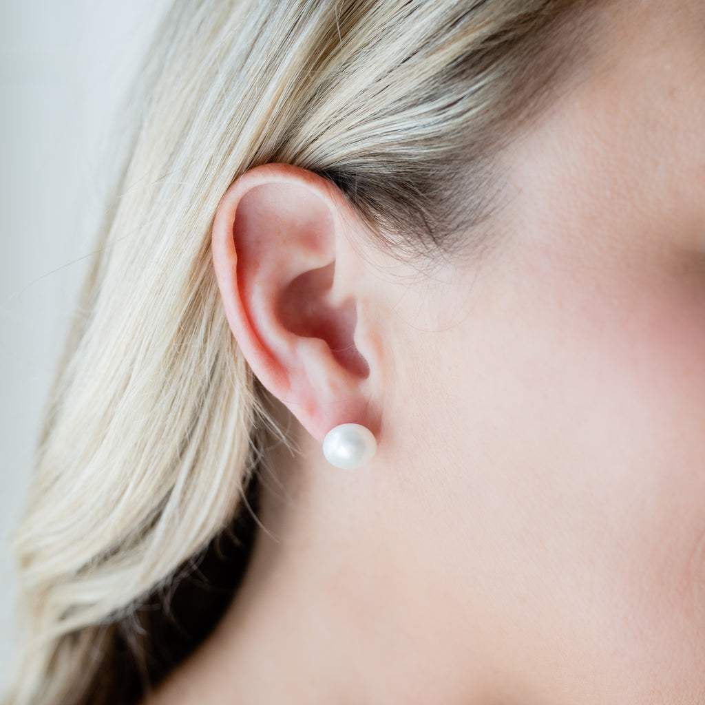 Classic Pearl Stud Earrings by Pearly Girls, showcasing versatile freshwater pearls set in sterling silver. These earrings epitomize elegance with their simple yet sophisticated design, combining the luster of pearls with the durability and shine of sterling silver.