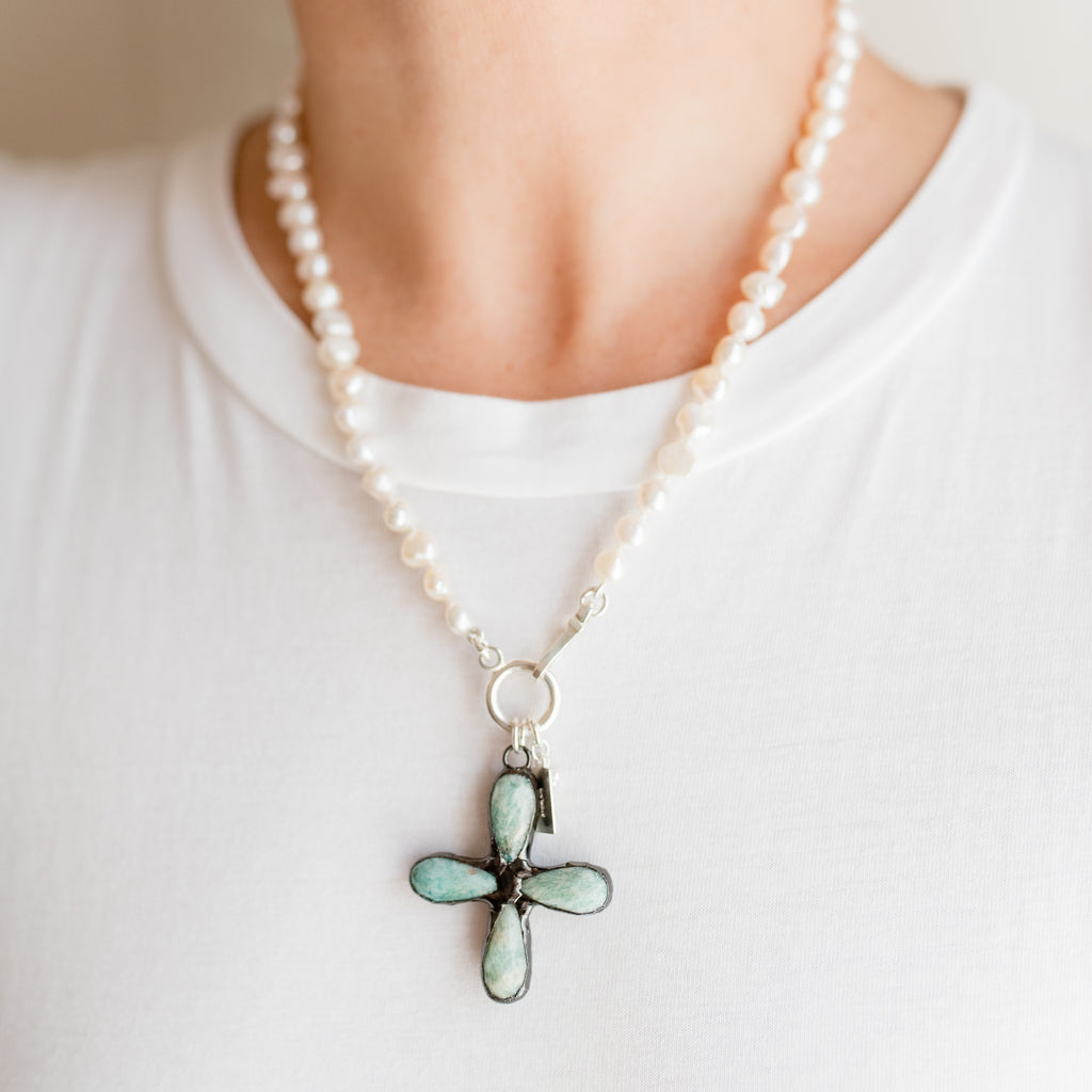 Kylie Pearl Necklace by Pearly Girls, showcasing an artisan Amazonite cross and freshwater pearl necklace. This piece beautifully combines the serene blue-green tones of an Amazonite cross with the classic elegance of freshwater pearls, creating a necklace that's both spiritually meaningful and aesthetically graceful.