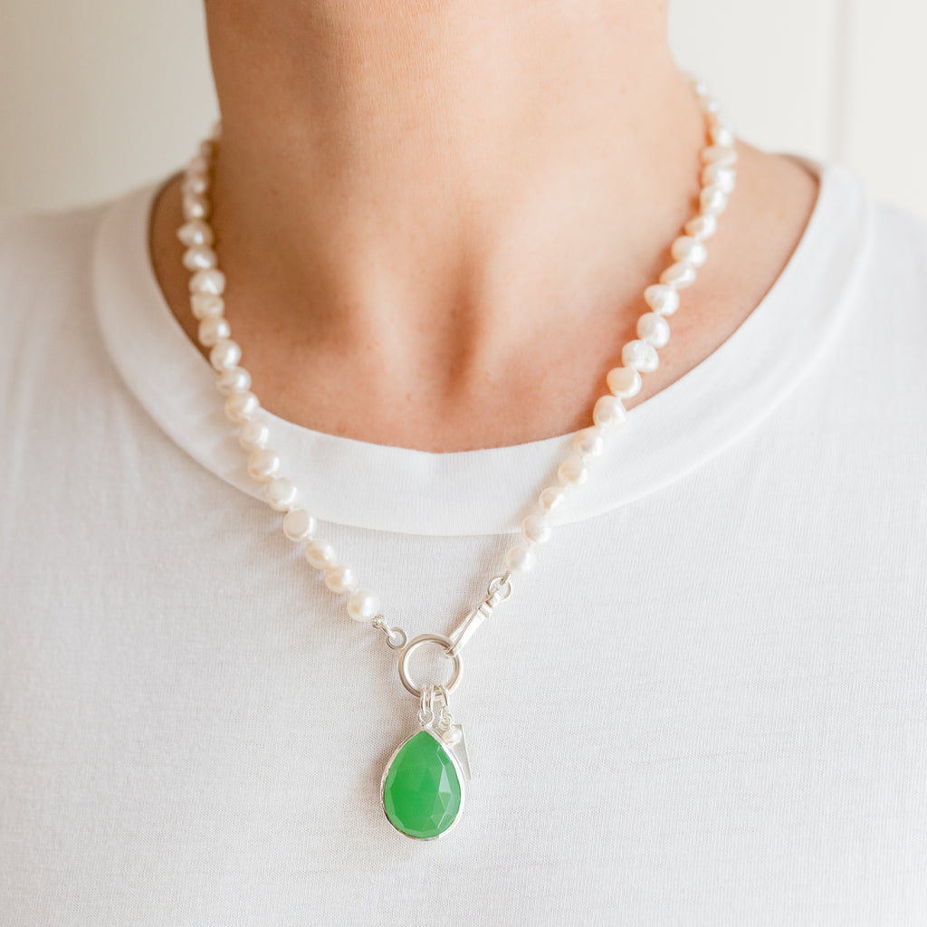 Margaret Pearl Necklace by Pearly Girls, featuring freshwater pearls with a radiant chalcedony pendant. This necklace elegantly combines the classic luster of pearls with the vibrant and translucent beauty of a chalcedony pendant, creating a piece that's both timeless and striking.