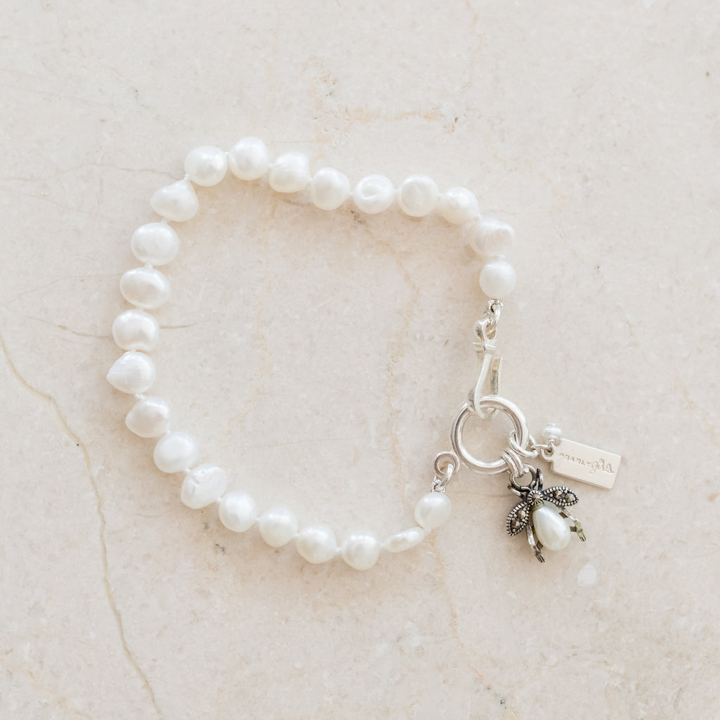 Betsy Pearl Bracelet by Pearly Girls, featuring a unique Pearls & Pollinators bee design. This bracelet elegantly combines classic pearls with a detailed bee charm, symbolizing nature's beauty and the importance of pollinators, creating a stylish and meaningful accessory.