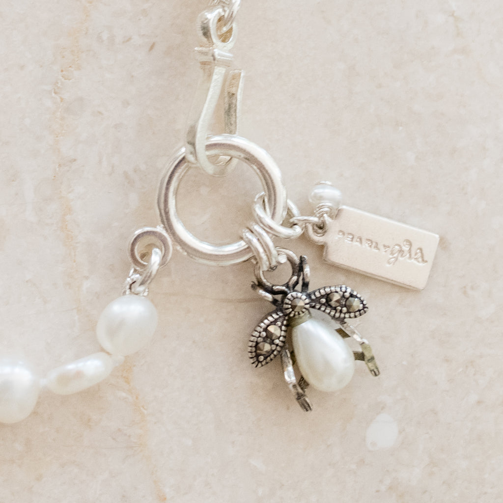Betsy Pearl Bracelet by Pearly Girls, featuring a unique Pearls & Pollinators bee design. This bracelet elegantly combines classic pearls with a detailed bee charm, symbolizing nature's beauty and the importance of pollinators, creating a stylish and meaningful accessory.