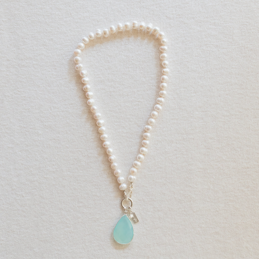 Exquisite Alex pearl necklace by Pearly Girls, featuring freshwater cultured ring pearls and a stunning sea green chalcedony pendant. The necklace combines the iridescent elegance of pearls with the vibrant charm of the chalcedony, creating a sophisticated and eye-catching piece