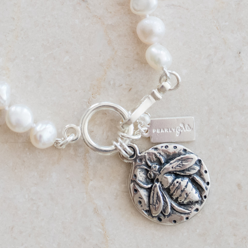 Lydia Silver Pearl Bracelets by Pearly Girls, showcasing a whimsical bee design. These bracelets combine the elegance of pearls with a playful silver bee motif, creating a delightful blend of classic sophistication and charming whimsy in their design.