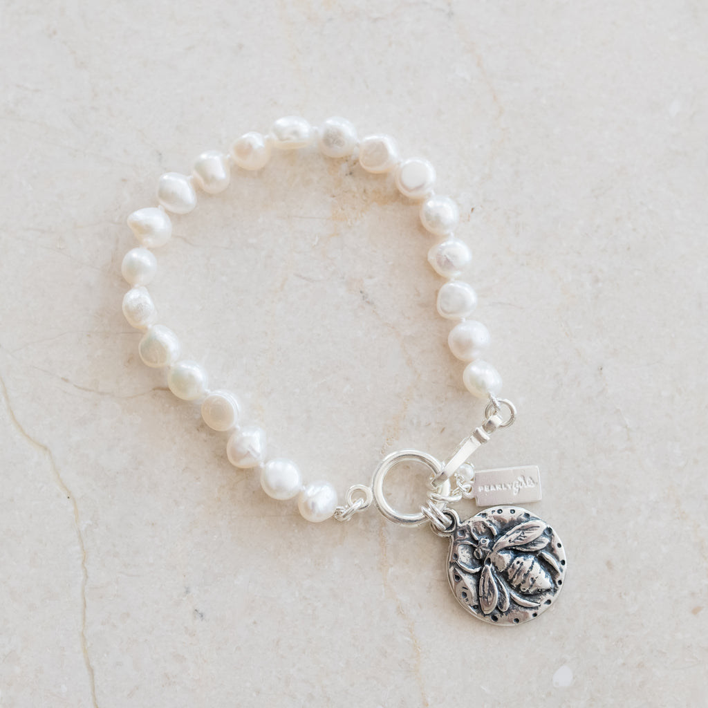 Lydia Silver Pearl Bracelets by Pearly Girls, showcasing a whimsical bee design. These bracelets combine the elegance of pearls with a playful silver bee motif, creating a delightful blend of classic sophistication and charming whimsy in their design.
