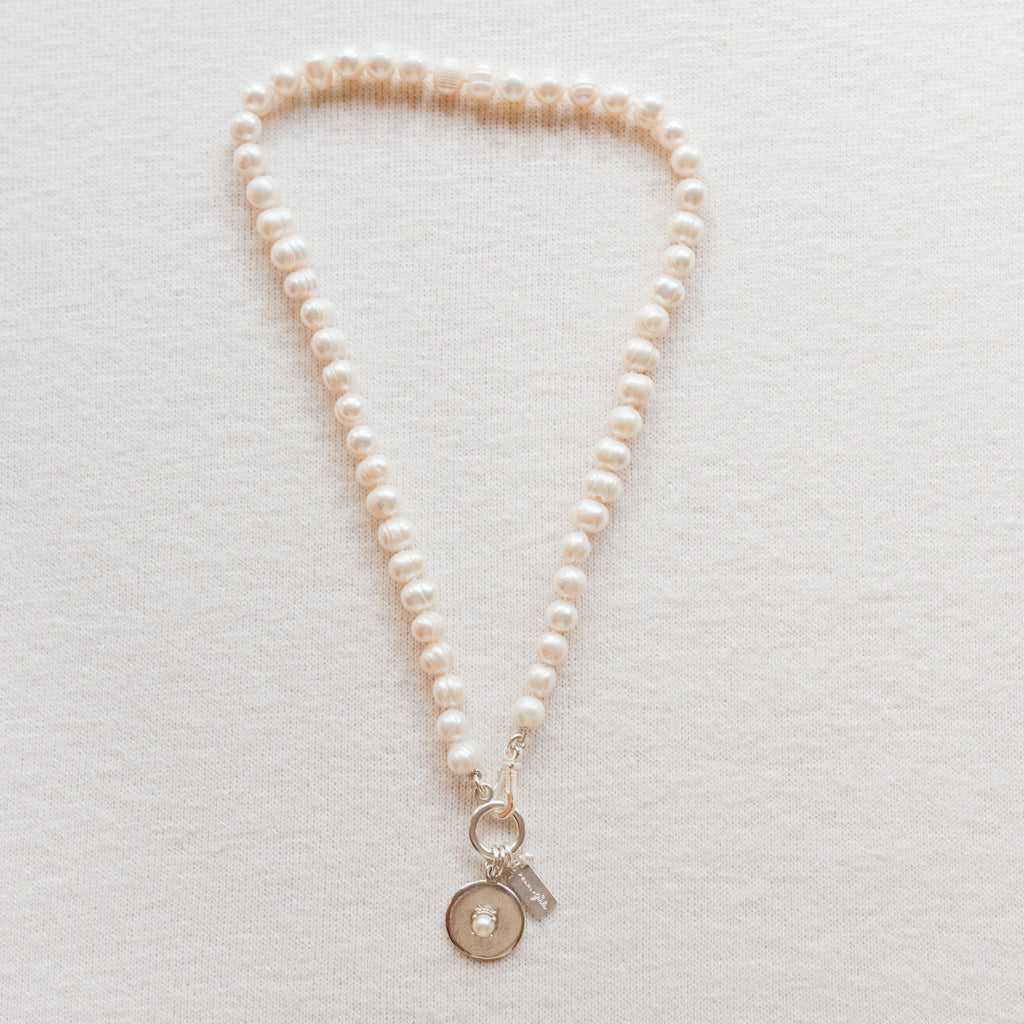 Hannah Pearl Necklace by Pearly Girls, showcasing ring pearls and sterling silver accents. This necklace elegantly pairs the distinctive texture of ring pearls with sleek sterling silver embellishments, creating a piece that blends organic beauty with a touch of modern elegance.