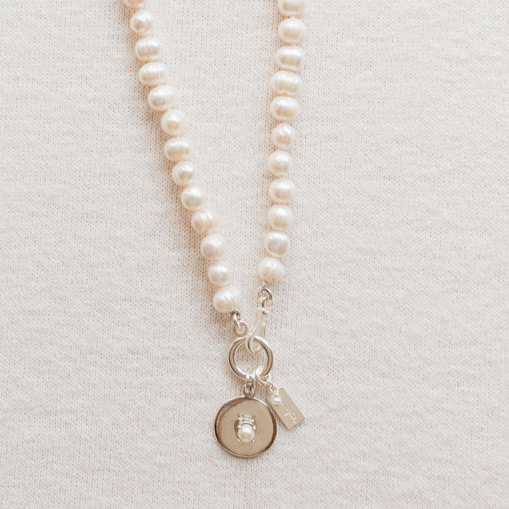 Hannah Pearl Necklace by Pearly Girls, showcasing ring pearls and sterling silver accents. This necklace elegantly pairs the distinctive texture of ring pearls with sleek sterling silver embellishments, creating a piece that blends organic beauty with a touch of modern elegance.