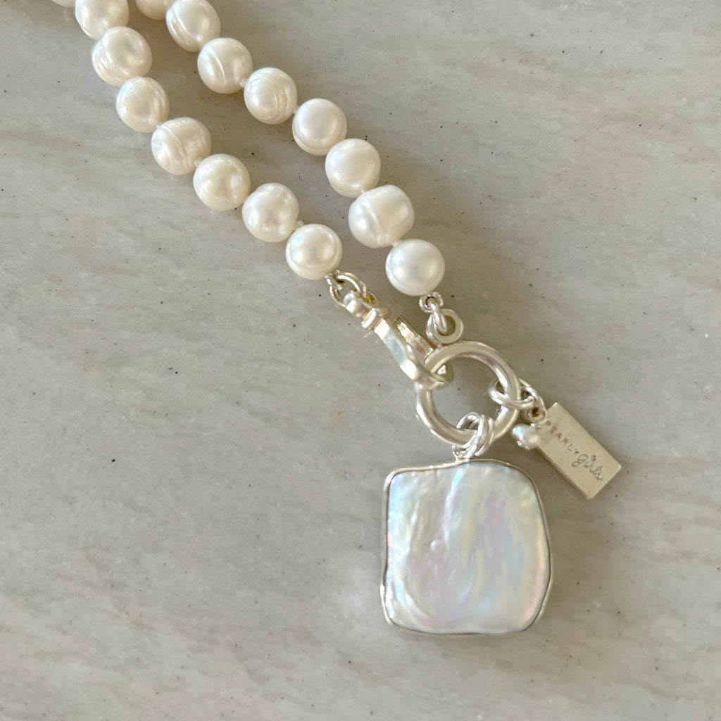 Willa Pearl Necklace by Pearly Girls, showcasing festive elegance with a Mother of Pearl pendant. This necklace combines the lustrous beauty of pearls with the iridescent charm of a Mother of Pearl pendant, creating a piece that is both celebratory and gracefully refined.