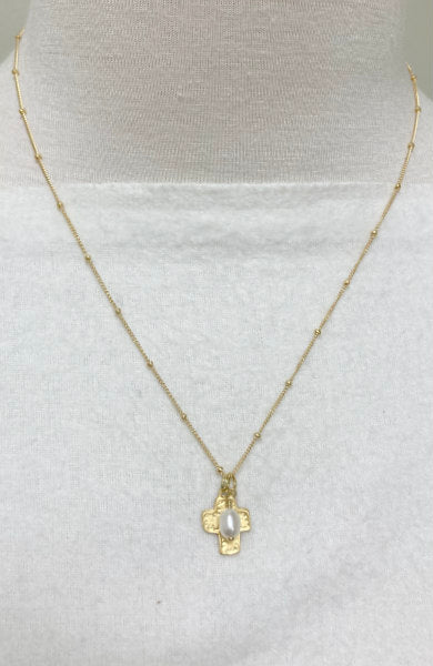 Sienna Gold-Filled Cross & Pearl Necklace by Pearly Girls, an embodiment of elegant design. This necklace features a gold-filled cross, representing a blend of faith and fashion, paired with the timeless charm of pearls, creating a sophisticated and meaningful piece.