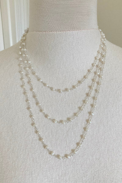 Classic Amelia pearl necklace by Pearly Girls, featuring a 60-inch strand of freshwater white round pearls. This versatile piece exudes elegance and can be styled in multiple ways, perfect for adding a touch of timeless sophistication to any outfit