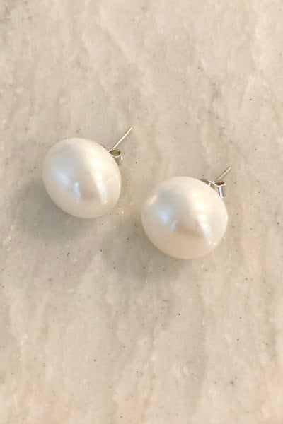 Classic XL Pearl Stud Earrings by Pearly Girls, a statement of bold elegance with radiant luster. These large pearl studs make a striking impact, showcasing the rich, natural sheen of pearls in a design that combines classic style with a bold, contemporary presence.