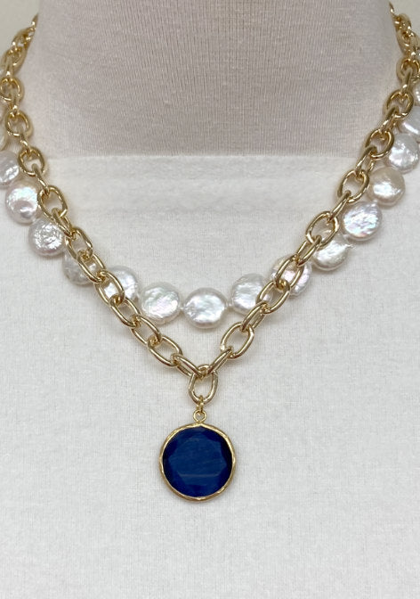 Susan Gold-Filled Round Chain Link Necklace by Pearly Girls, featuring a Turkish blue cat-eye accent. This necklace combines the contemporary style of round gold-filled chain links with the mesmerizing depth of a Turkish blue cat-eye stone, creating a modern and captivating piece.