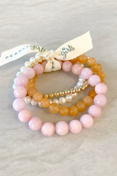 Cherry Quartz and Pearl Bracelet Bundle by Pearly Girls, a vibrant medley of timeless elegance. This bundle pairs the vivid, warm hues of cherry quartz with the classic beauty of pearls, creating a striking contrast and a harmonious blend of color and refinement.