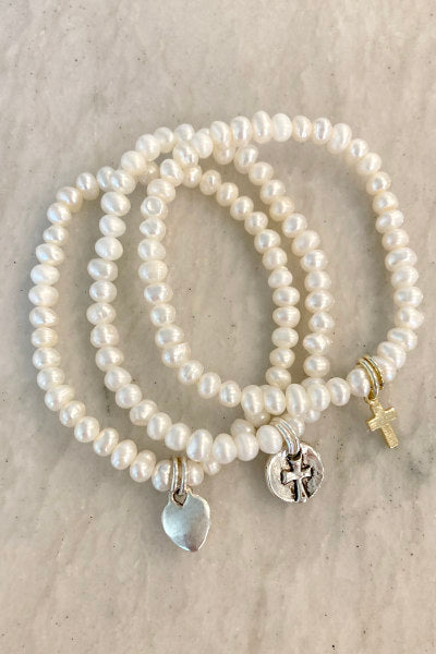 Child Pearl Stretchy Bracelet by Pearly Girls, featuring freshwater pearls and customizable charms. This bracelet is designed with the delicate beauty of pearls, offering a stretchy, comfortable fit for children, and allows for personalization with a choice of charming, fun charms.