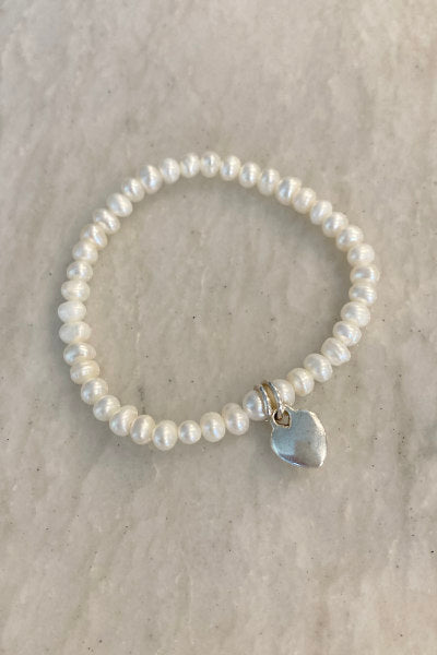 Child Pearl Stretchy Bracelet by Pearly Girls, featuring freshwater pearls and customizable charms. This bracelet is designed with the delicate beauty of pearls, offering a stretchy, comfortable fit for children, and allows for personalization with a choice of charming, fun charms.