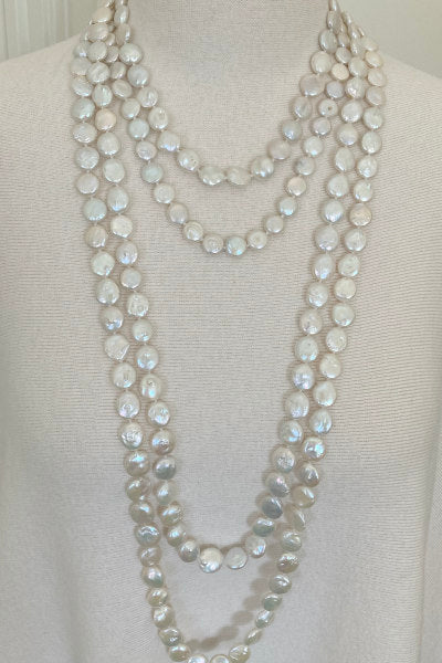 Flat Coin Pearl Necklace by Pearly Girls, characterized by iridescent elegance and available in versatile lengths. This necklace highlights the unique, flat profile of coin pearls, offering a contemporary twist on traditional pearl elegance, adaptable for various styles and occasions.