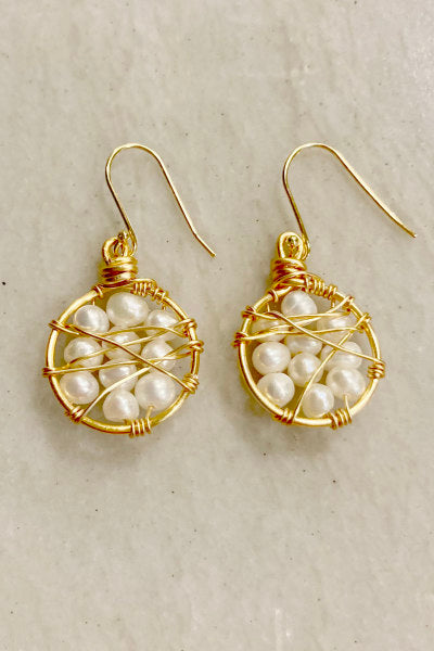 Gold-Filled Web Hoops Earrings by Pearly Girls, featuring freshwater pearls and an intricate design. These earrings combine the classic elegance of pearls with a unique, web-like gold-filled hoop structure, offering a blend of traditional beauty and contemporary artistic flair.