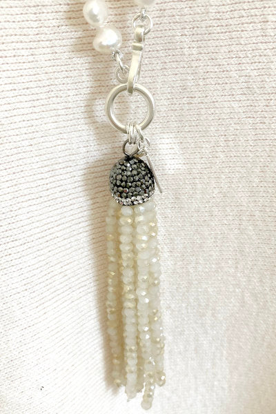 Elise Pearl Necklace by Pearly Girls, featuring freshwater nugget pearls and a crystal bead tassel. This necklace combines the rustic charm of irregularly shaped nugget pearls with the sparkling elegance of a crystal bead tassel, creating a blend of natural beauty and refined glamour.