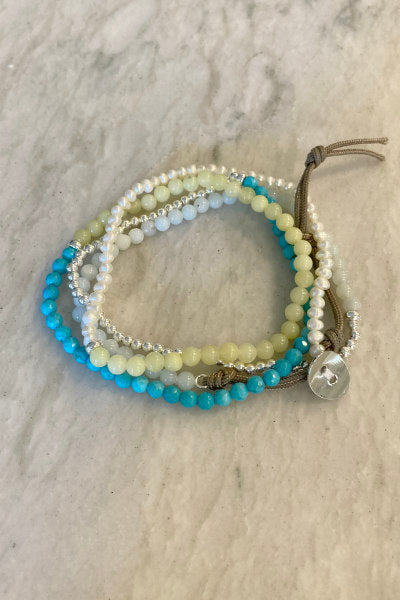 Emma Gemstone Wrap Bracelet by Pearly Girls, featuring a triple-wrap design and colorful gemstones. This bracelet artfully combines a variety of vibrant gemstones in a triple-wrap style, creating a playful and colorful accessory that's both stylish and versatile.
